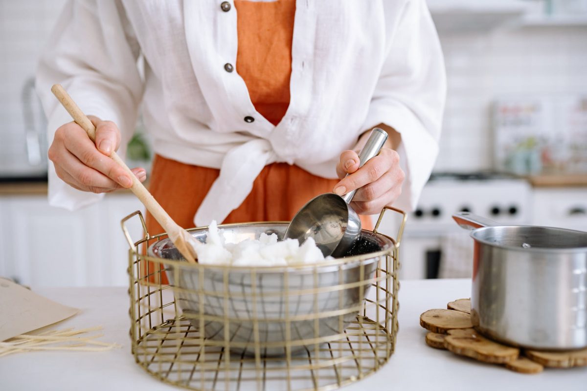 person preparing soy wax for candle